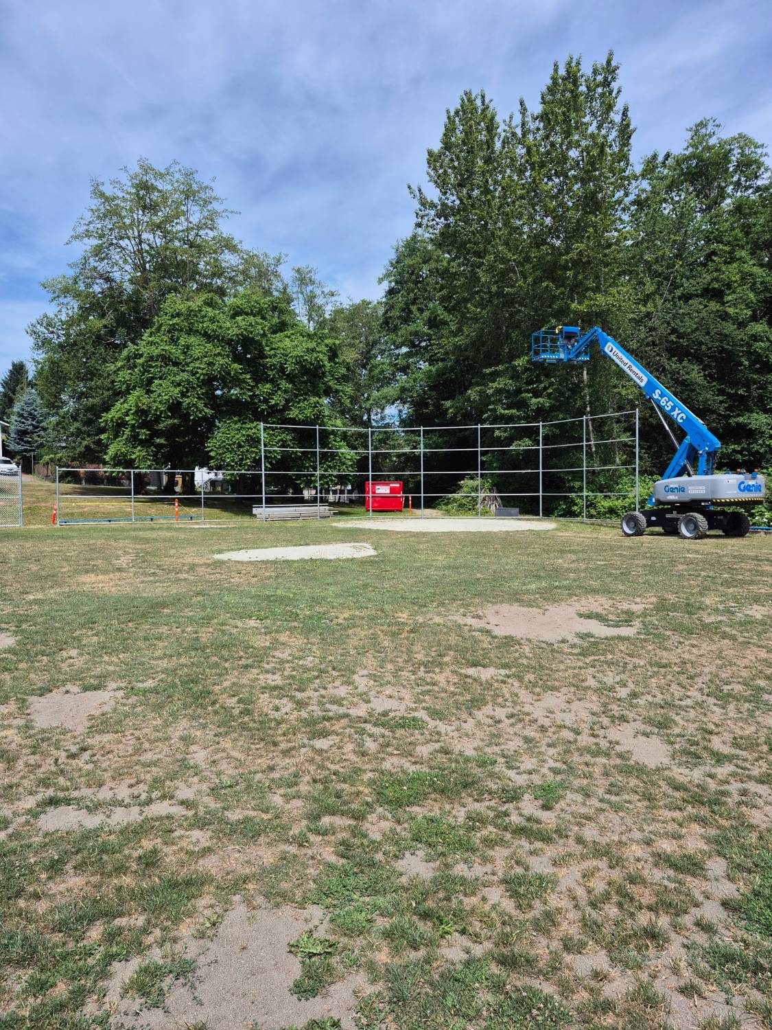 Backstop posts installed using a lift
