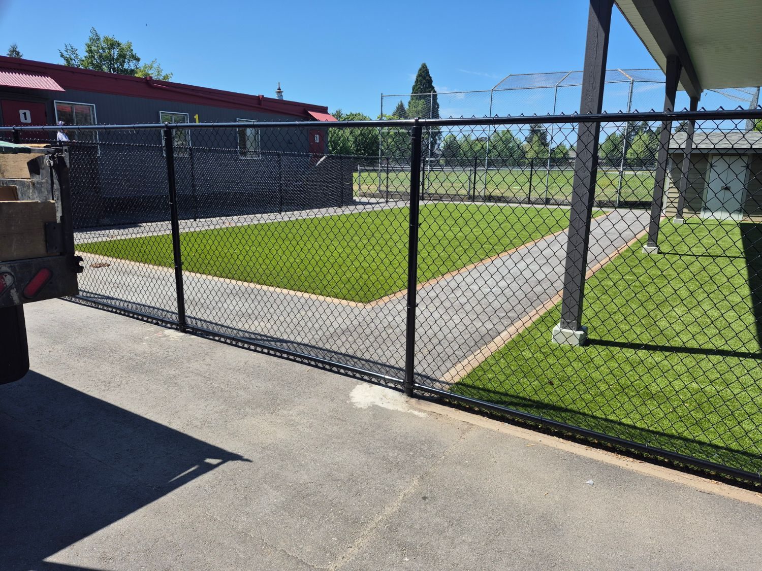 Black chain link around a school turf field