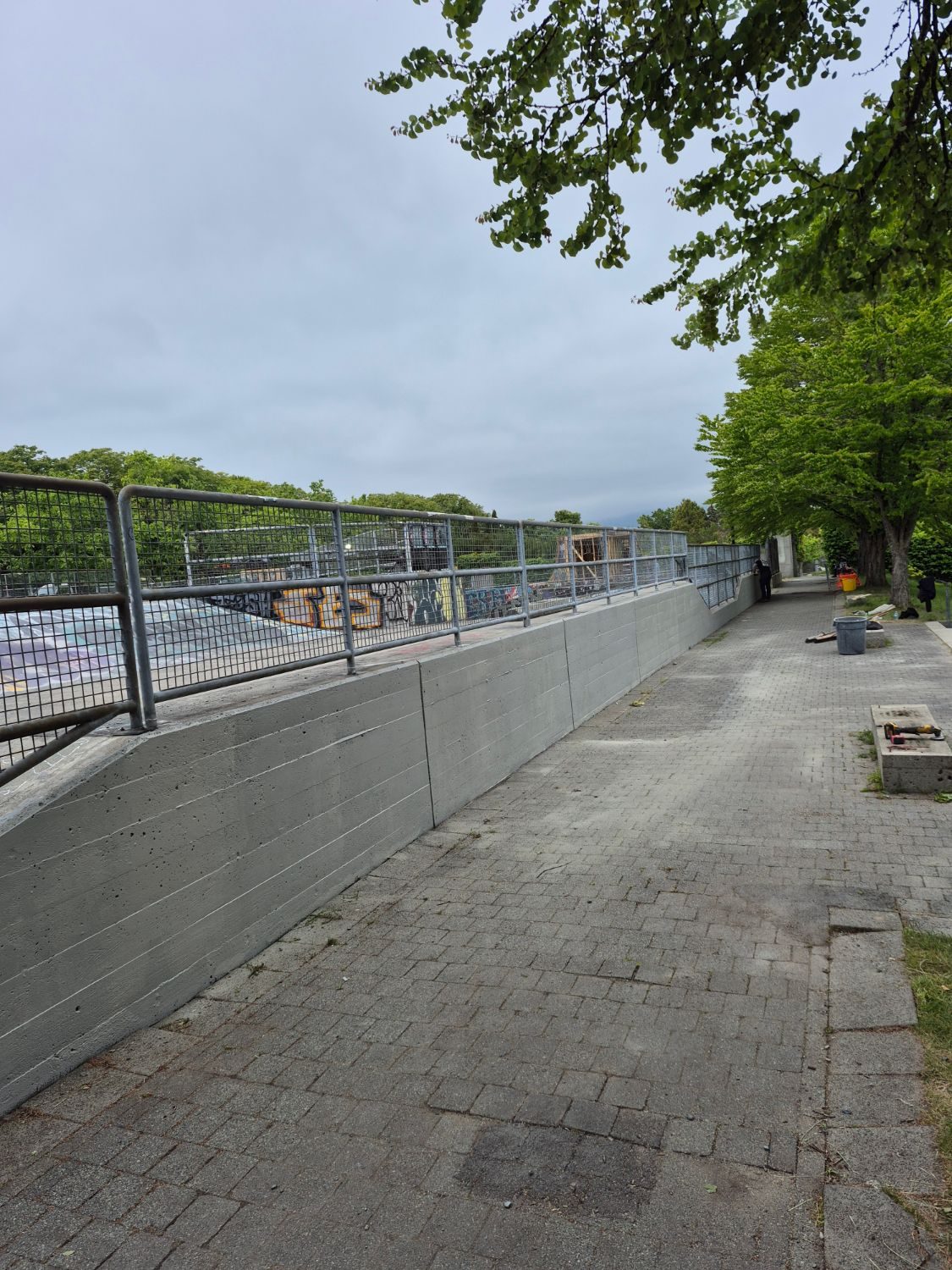 Concrete wall with steel mesh railing at a skate park