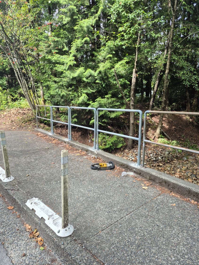 Galvanized steel guard rail along a path
